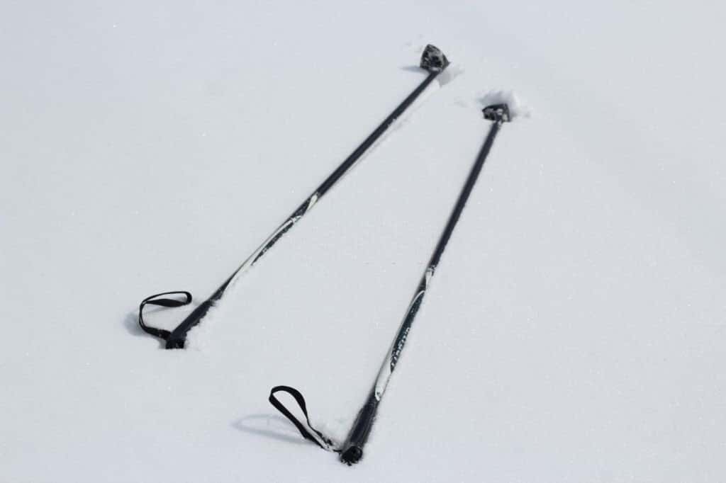 A ski poles lie in the snow. Ski vacation.