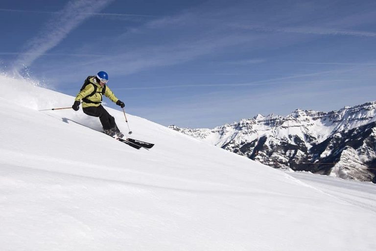 Female skier in open powder field