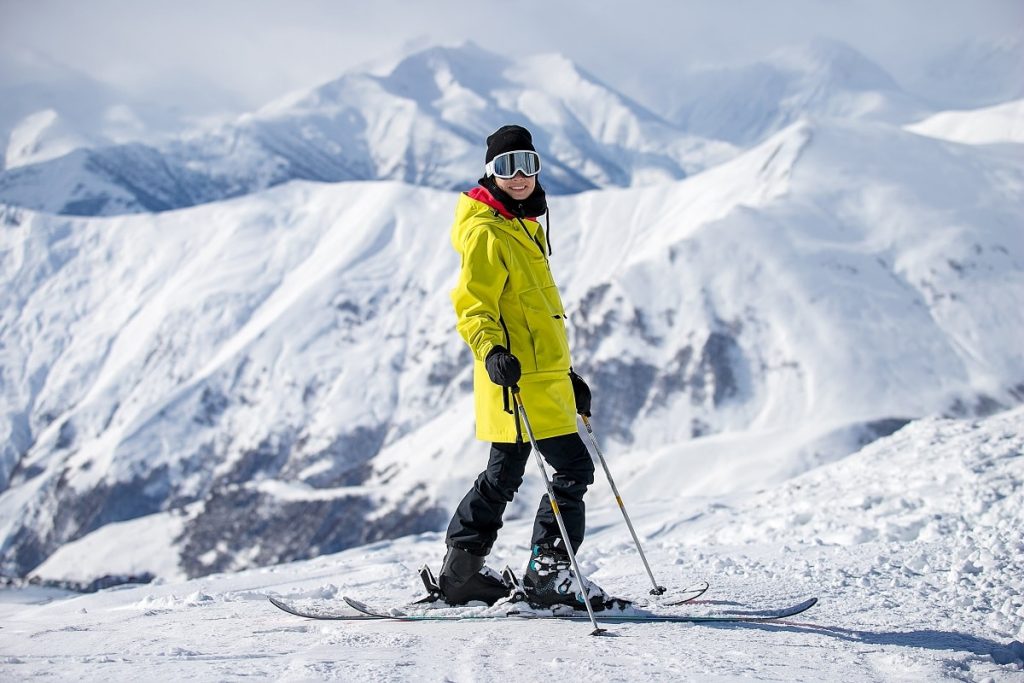 A,Skier,In,A,Fashionable,Yellow,Jacket,Is,Skiing,Against
