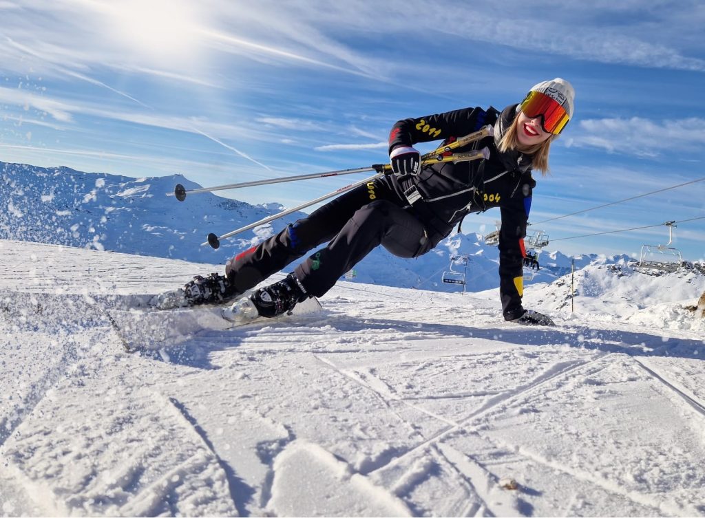 a woman is skiing down a snowy hill
