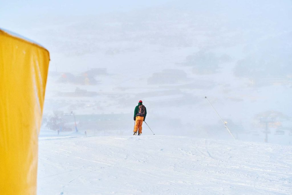 a man riding skis on top of a snow covered slope